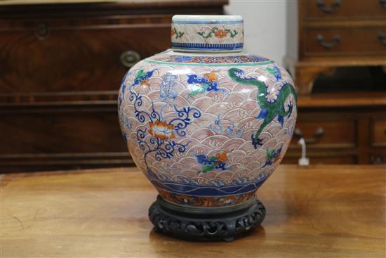 A Chinese doucai dragon ovoid jar and cover, Yongzheng four character mark but 19th century, height 24.5cm excl. wood stand